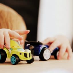 Child playing with toy cars.