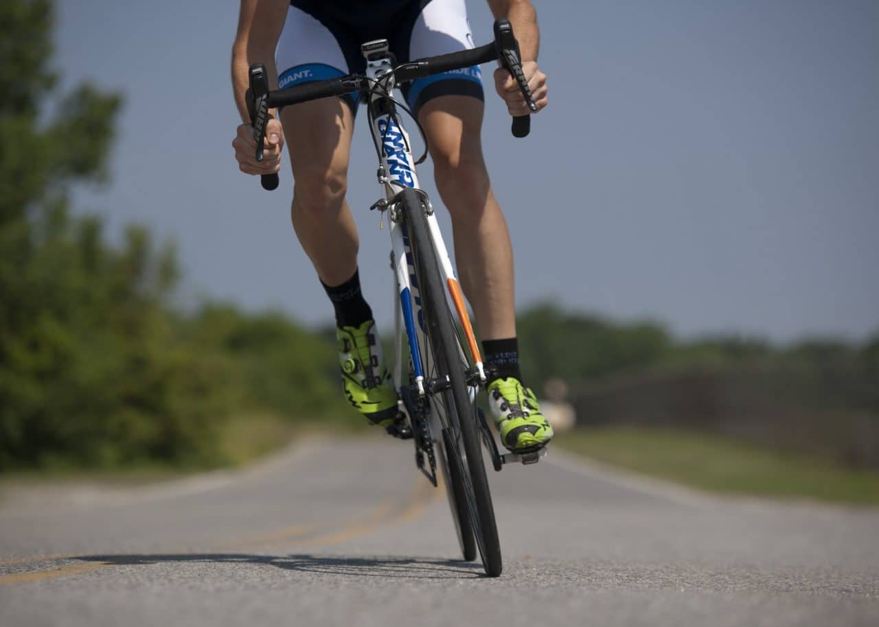 Man cycling on an open road.