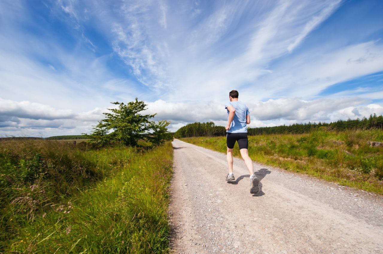 Man jogging outside on a clear day.