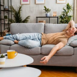Man lying on the couch taking a nap.