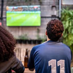 Friends watch football at a bar