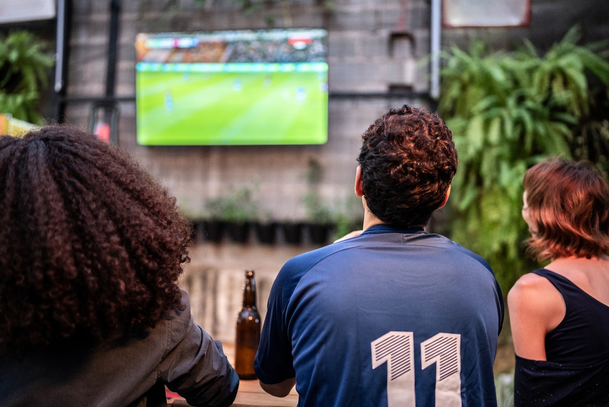 Friends watch football at a bar